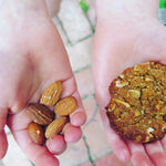 Gluten free ANZAC biscuits, gluten free cookies, gluten free baking with almond, little hands holding gluten free cookie made with almond