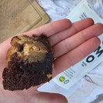 Hand holding gluten free brookie made with YOMO gluten free choc chip mix, gluten free brownie, gluten free choc chip cookie, vegan brookie