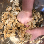 Child's hands mixing choc chip cookie dough, gluten free baking with kids, best gluten free choc chip cookies, YOMO gluten free choc chip mix in action